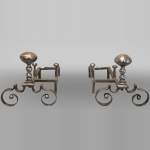 Pair of scrolled andirons topped with a ball
