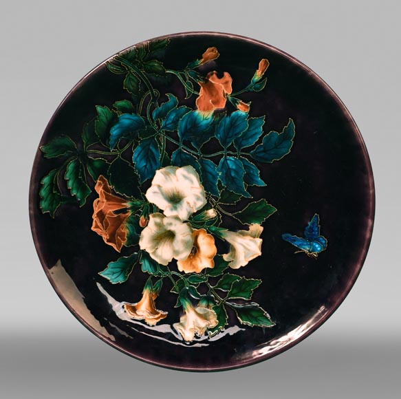 Théodore DECK, circular dish decorated with flowers and butterfly on an eggplant background, after 1870-0