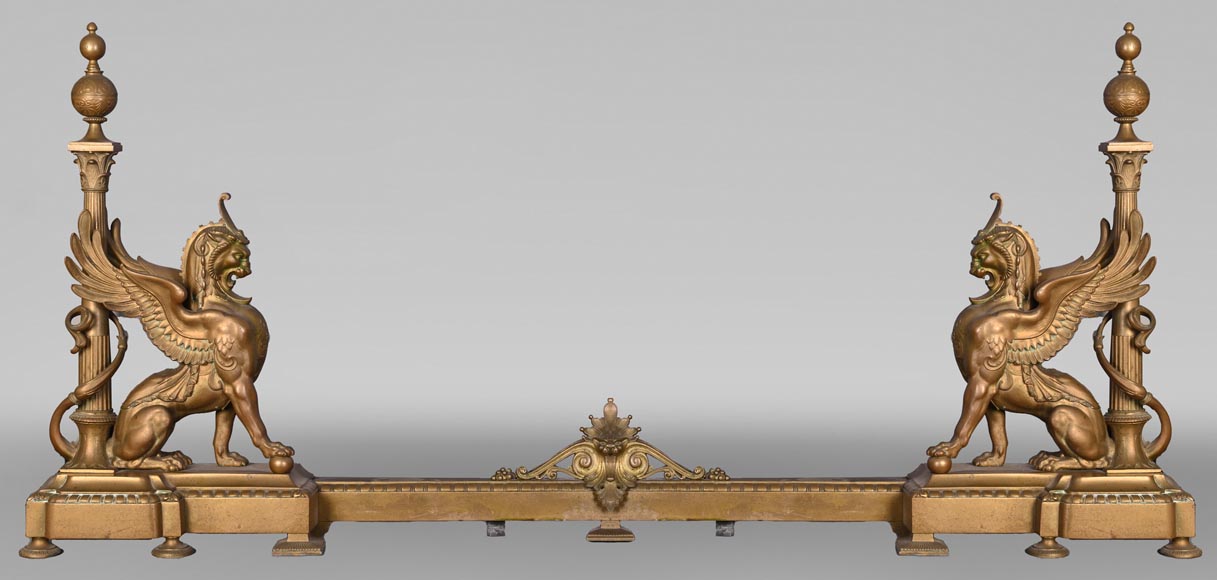 Pair of Egyptian-style gilt-bronze firedogs with confronting griffins Pair of Egyptian-style gilt-bronze firedogs with confronting griffins-0