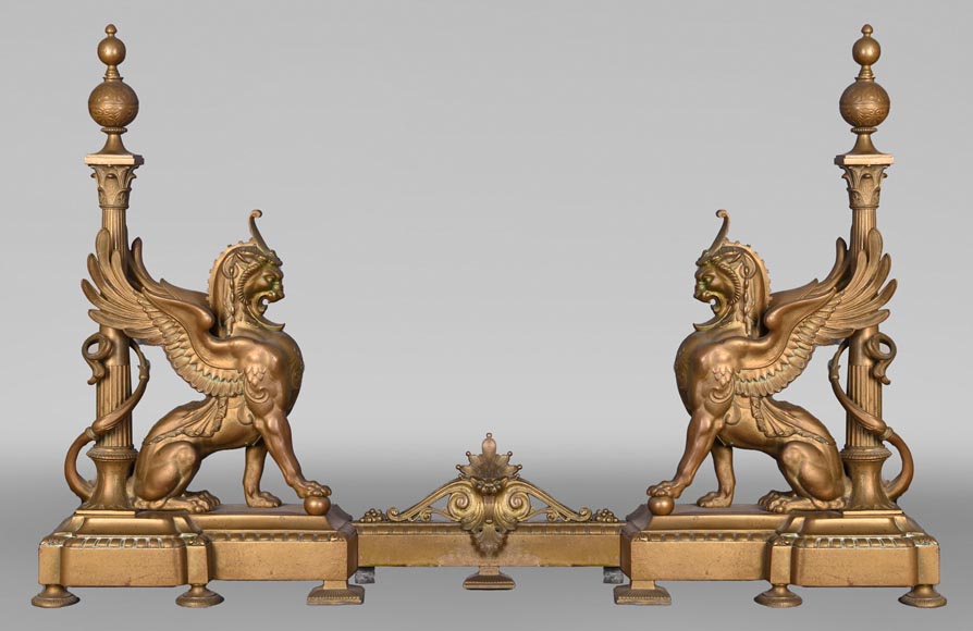 Pair of Egyptian-style gilt-bronze firedogs with confronting griffins Pair of Egyptian-style gilt-bronze firedogs with confronting griffins-1