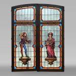 Double stained glass window in neo-Renaissance style depicting two figures with offerings