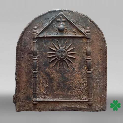 Cast iron fireback dated 1693, decorated with a radiant sun and architectural symbols
