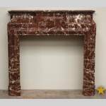 Antique Louis XIV style marble mantel with acroterion