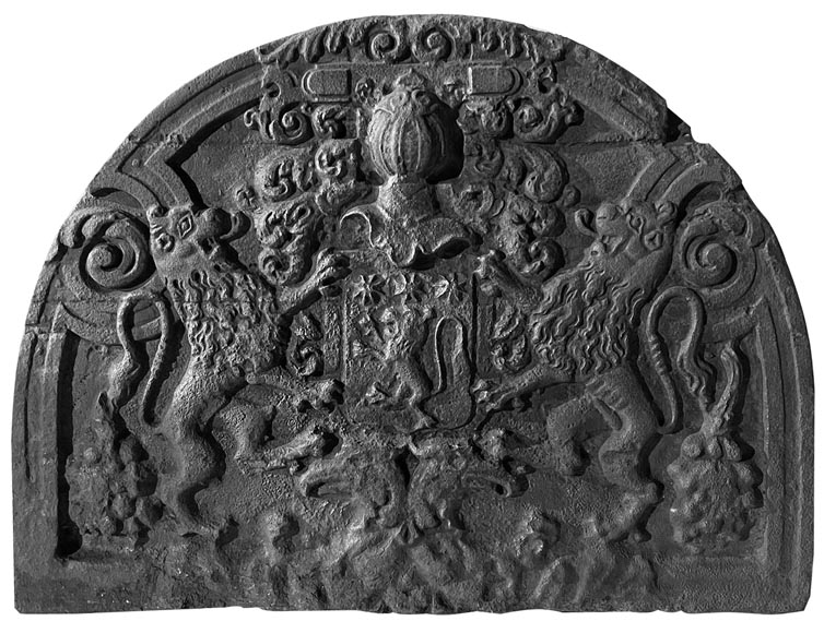 A semicircular cast iron fireplace plaque, decorated with a coat of arms, surmounted by a helmet and framed by lions.-0