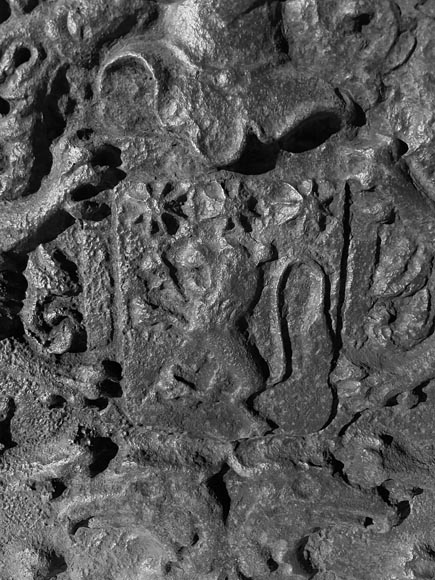 A semicircular cast iron fireplace plaque, decorated with a coat of arms, surmounted by a helmet and framed by lions.-4