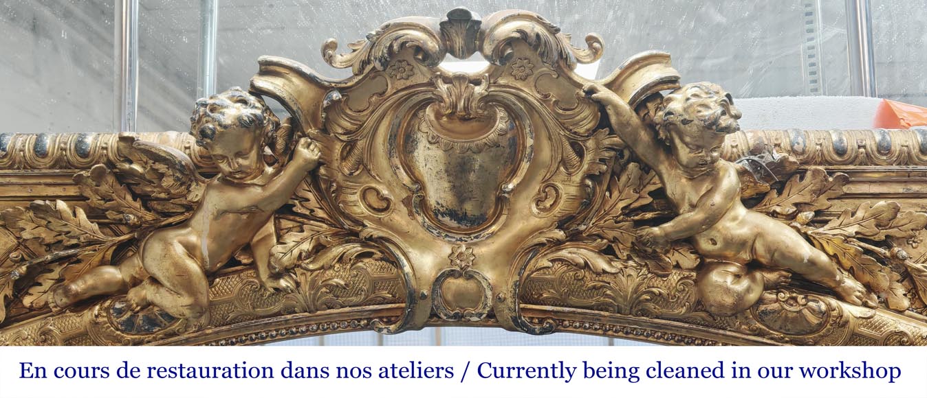 A richly gilded trumeau in the Napoleon III style, decorated with putti A richly gilded trumeau in the Napoleon III style, decorated with putti-1