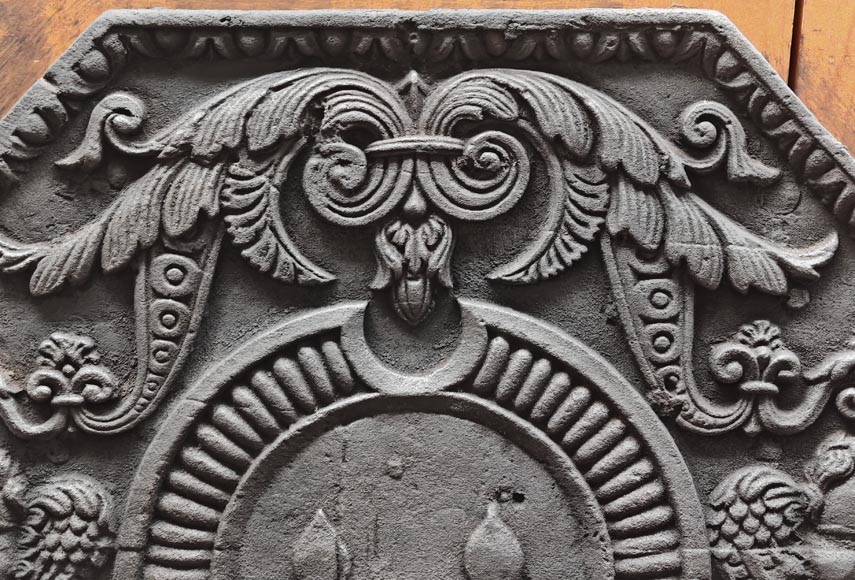 Cast iron fireplace plaque bearing the Arms of France, framed by cherubs-1