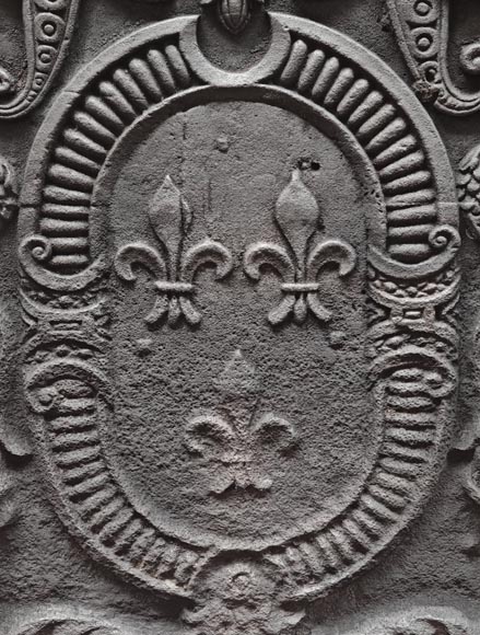 Cast iron fireplace plaque bearing the Arms of France, framed by cherubs-2