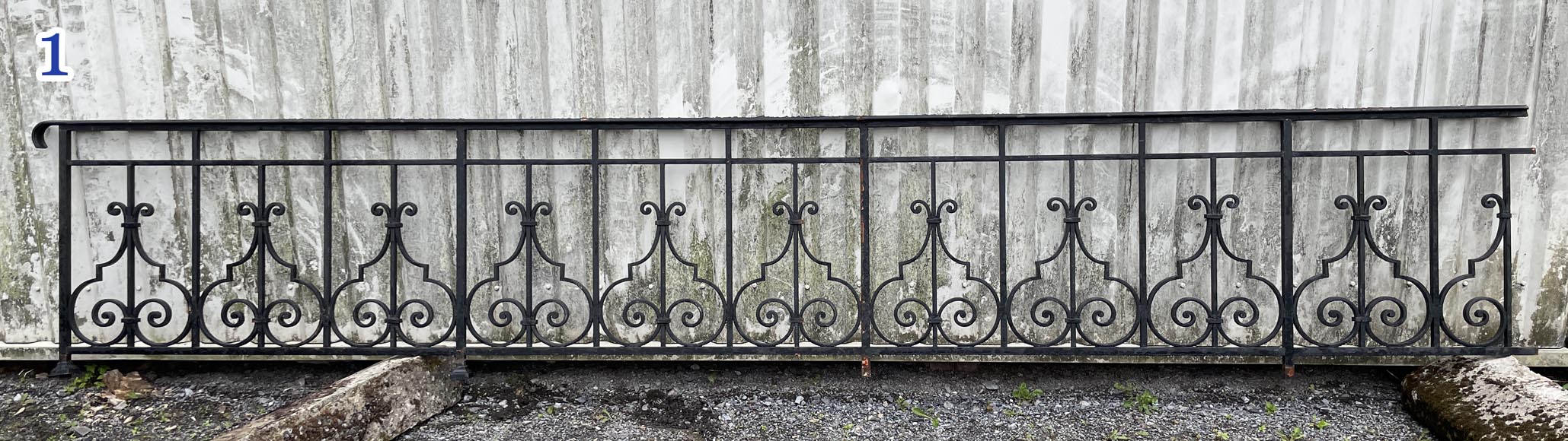 Set of wrought-iron railings featuring a design of scrolls and volute terminals, including both straight and raked sections Set of wrought-iron railings featuring a design of scrolls and volute terminals, including both straight and raked sections-1