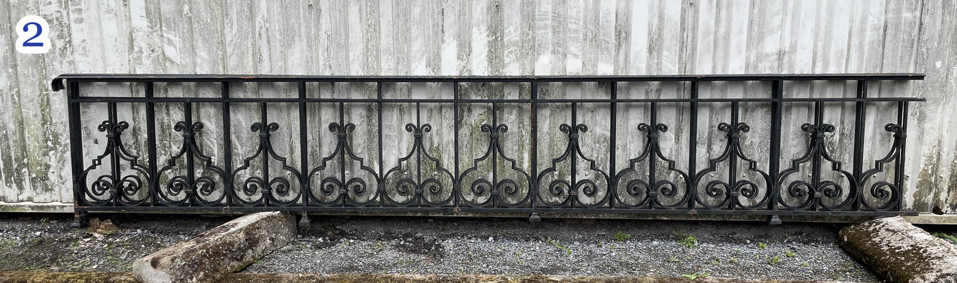 Set of wrought-iron railings featuring a design of scrolls and volute terminals, including both straight and raked sections Set of wrought-iron railings featuring a design of scrolls and volute terminals, including both straight and raked sections-2