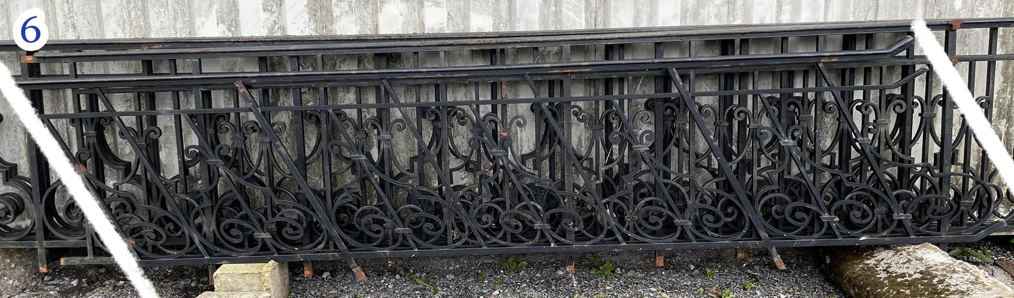 Set of wrought-iron railings featuring a design of scrolls and volute terminals, including both straight and raked sections Set of wrought-iron railings featuring a design of scrolls and volute terminals, including both straight and raked sections-6