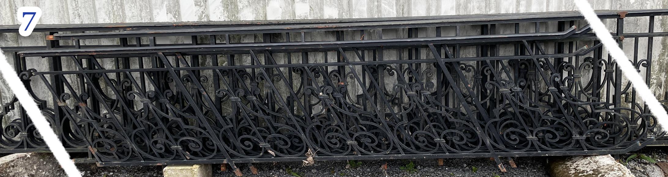 Set of wrought-iron railings featuring a design of scrolls and volute terminals, including both straight and raked sections Set of wrought-iron railings featuring a design of scrolls and volute terminals, including both straight and raked sections-7