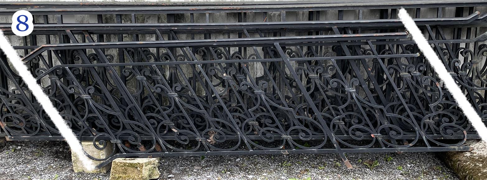 Set of wrought-iron railings featuring a design of scrolls and volute terminals, including both straight and raked sections Set of wrought-iron railings featuring a design of scrolls and volute terminals, including both straight and raked sections-8