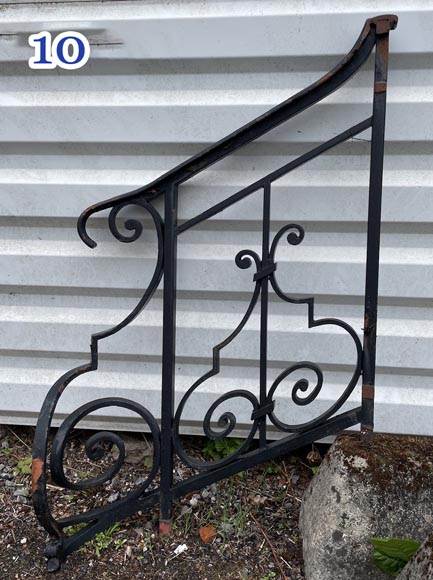 Set of wrought-iron railings featuring a design of scrolls and volute terminals, including both straight and raked sections Set of wrought-iron railings featuring a design of scrolls and volute terminals, including both straight and raked sections-10