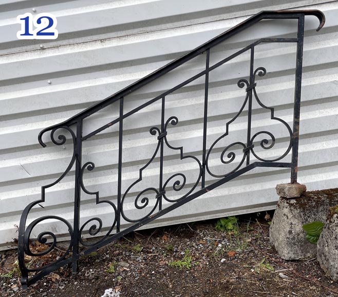 Set of wrought-iron railings featuring a design of scrolls and volute terminals, including both straight and raked sections Set of wrought-iron railings featuring a design of scrolls and volute terminals, including both straight and raked sections-12