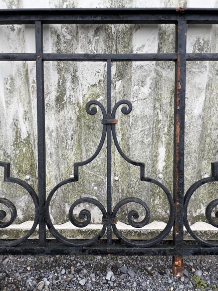 Set of wrought-iron railings featuring a design of scrolls and volute terminals, including both straight and raked sections Set of wrought-iron railings featuring a design of scrolls and volute terminals, including both straight and raked sections-17