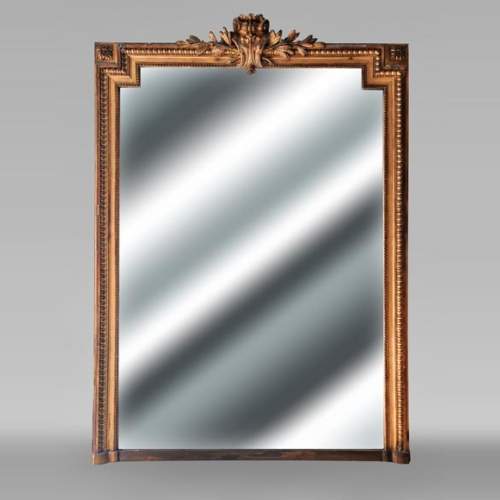 Richly decorated Louis XVI style gilt trumeau mirror