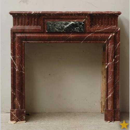 Louis XIV style mantel in Rouge du Nord marble
