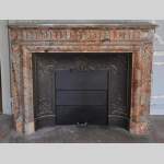 Beautiful antique Louis XIV style fireplace with acroterion in Sarrancolin Fantastico marble