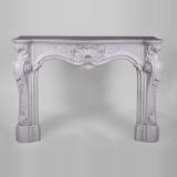 Beautiful antique Louis XV style fireplace with opulent decor in white Carrara marble