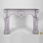 Beautiful antique Louis XV style fireplace with opulent decor in white Carrara marble