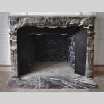 Beautiful antique Regence style fireplace in Campan Grand Melange marble, 19th c.