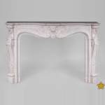 Beautiful antique Louis XV style fireplace with rich decor in white Carrara marble