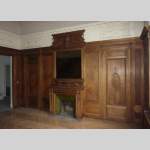 Napoleon III style paneled room with fireplace and mirror, chimeras decor, in carved wood