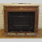 Antique Louis XVI style fireplace mantel with round corners in Griotte marble and gilt bronze ornaments