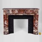 Beautiful antique Louis XVI style fireplace with flutings in Onyx rouge with its cast iron insert