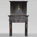 Antique Neo-Renaissance fireplace in oak with a portrait of woman