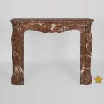 An antique Louis XV style fireplace, Pompadour model, made out of Rouge du Nord marble