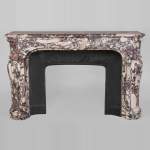 Exceptional Regence style fireplace in Violet Breccia marble decorated with shells