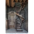 Beautiful spiral staircase with a wrought iron railing decorated with flowers and arabesques