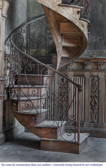 Beautiful spiral staircase with a wrought iron railing decorated with flowers and arabesques-1