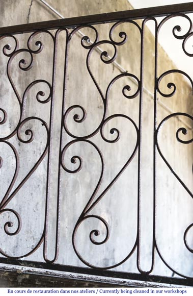 Beautiful spiral staircase with a wrought iron railing decorated with flowers and arabesques-5