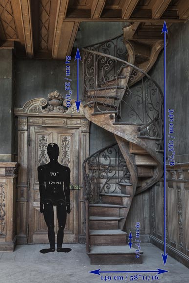 Beautiful spiral staircase with a wrought iron railing decorated with flowers and arabesques-8