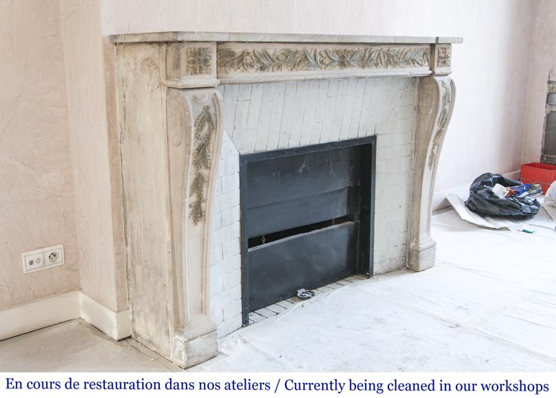 An antique Louis XVI style fireplace, made out of stone, with foliated decoration-3