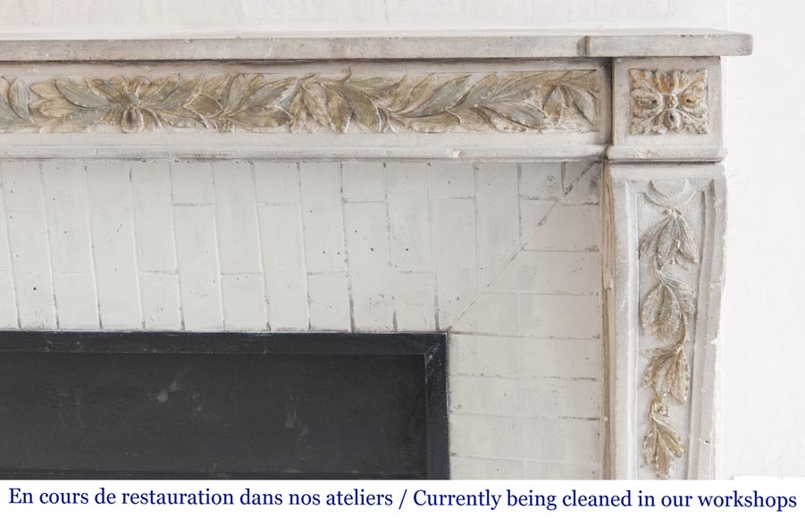 An antique Louis XVI style fireplace, made out of stone, with foliated decoration-7