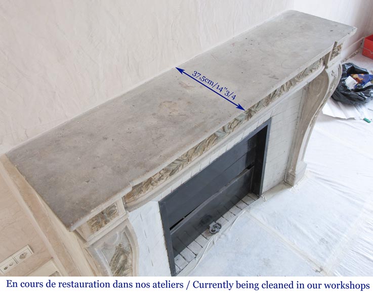 An antique Louis XVI style fireplace, made out of stone, with foliated decoration-9