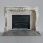An antique Louis XV style fireplace, made out of stone