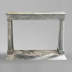 An antique Empire style fireplace made out of blue Turquin marble with detached columns