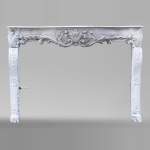 A beautiful antique richly sculpted fireplace from Louis XV period made out of painted oak
