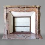 An antique Louis XV style fireplace, Pompadour model, made out of Enjugerais marble
