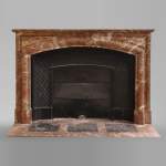 An antique Louis XIV style fireplace, made out of Rouge Royal marble