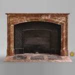 An antique Louis XIV style fireplace, made out of Rouge Royal marble