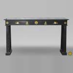 An antique Empire fireplace made out of black marble, witrh bronze ornaments and detached columns