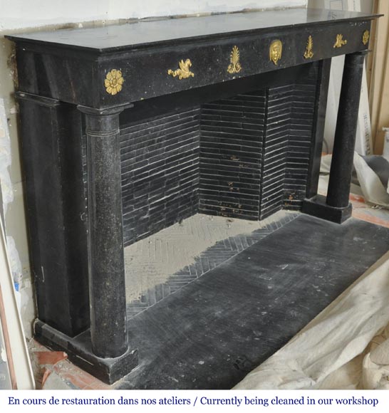 An antique Empire fireplace made out of black marble, witrh bronze ornaments and detached columns-5