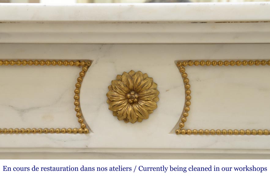 An antique Louis XVI style fireplace made out of Carrara marble with gilded bronze ornaments-1