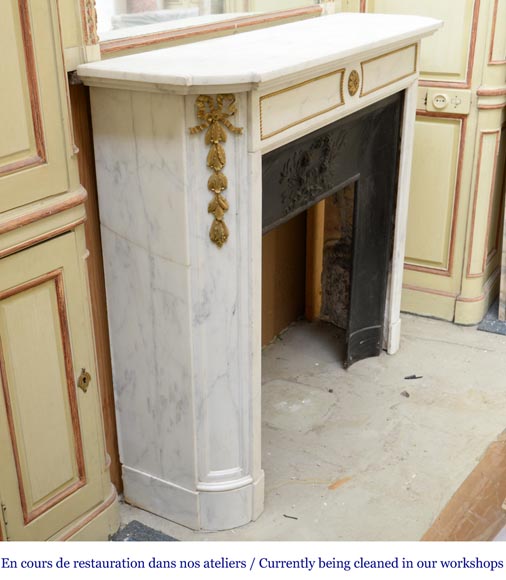 An antique Louis XVI style fireplace made out of Carrara marble with gilded bronze ornaments-2